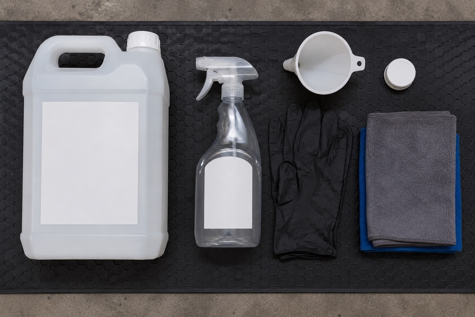Five litre degreaser container, blank trigger bottle, funnel, gloves, and cloths arranged for workshop refilling
