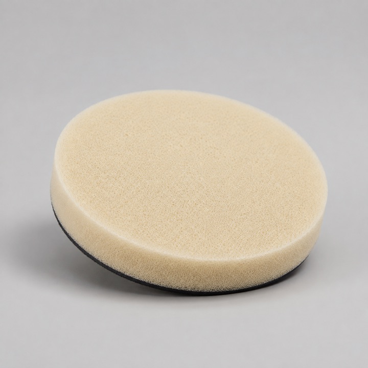 AI-generated close-up of a generic foam polishing pad with a fine porous surface